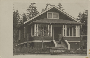 Postcard of a man standing in front of an unidentified home.