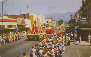 Postcard is a photograph of a Gladiola Parade in Grants Pass, Oregon along Highway 99.