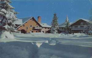 Postcard of a snowy scene outside of the Challenger Inn in Sun Valley, Idaho.  | Challenger Inn and Village Square. Sun Valley, Idaho.