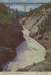 Postcard is of a bridge near the Moyie Dam near Bonners Ferry, Idaho. | Moyie River Bridge, Highway 2. Moyie River Bridge, 464 ft. high and 1222 ft. long, is located 9 miles northeast of Bonners Ferry on Hwy. 2. This exciting span was finished in 1965, a 3 year project. It is considered to be one of North Idaho's most spectacular highway views. The Bonners Ferry municipal powerhouse is seen at the base of turbulent Moyie Falls. Moyie Falls was a highly regarded scenic point before the bridge was built.