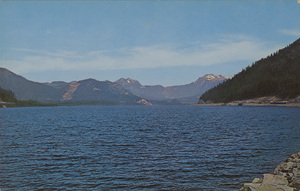Postcard of Lake Keechelus in Washington state.  | Lake Keechelus. One of the many storage reservoirs which collect the waters from the melting snows of the Cascade mountains and make them available for the irrigation projects of eastern Washington. Sunset highway (U.S. No. 10), the main cross state highway, may be seen along the shore on the right.