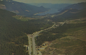 Postcard of Snoqualmie Pass in Washington state.  |  Snoqualmie Pass - U.S. Hiway No. 10, Washington. This view looks east from the summit towards beautiful Keechelus Lake. Although a season's snowfall averages nearly 500 inches to provide some of America's finest skiing in four major resorts, the most modern snow removal equipment is used to keep this main East-West mountain pass open all winter.
