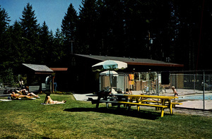 Postcard of a swimming pool at a campground outside of Olympia, Washington. |  Jerry's American Heritage K.O.A. Located 6 miles south of Olympia on I-5, exit 99, turn east and follow signs. Tents, Campers, Trailer spaces, hot showers, clean restrooms. Conveniently located to visit Mt. Rainier, Olympic National Park, Ocean Beaches and State Capitol. 9610 Kimmie Street, S.W., Olympia, Washington 98502. (206) 943-8778.