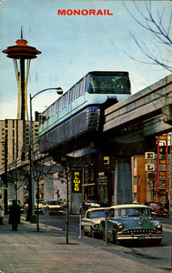 Postcard of the Monorail in Seattle, Washington. | Two symbols of modern times. The sleek Monorail, first of its kind in America, swiftly whisks visitors to the Seattle World's Fair grounds and back to beautiful downtown Seattle. Like a sentinel watching, stands the 600-foot Space Needle.