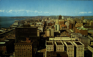 Postcard of the skyline of Seattle, Washington. | Seattle skyline as viewed from atop the 42 story Smith Tower. The financial district is in the foreground while on the left may be seen the Alaskan Way viaduct which carries through traffic along the waterfront. Lake Union is on the far right.
