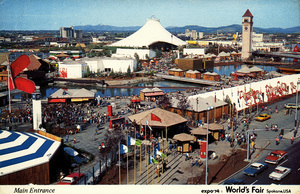 Postcard of the entrance to expo'74, the World's Fair in Spokane, Washington in 1974.  | The main entrance to Expo '74, the only major international exposition in the United States during the 1970's bicentennial decade. "Celebrating tomorrow's fresh new environment." Glistening islands and riverbanks of the Spokane River, open spaces with colorful plazas, dancing fountains, gardens and greenery, and many worldwide pavilions and exhibits. All created to illustrate that Man can live, work and play in harmony with his environment. Official Expo '74 World's Fair Card.