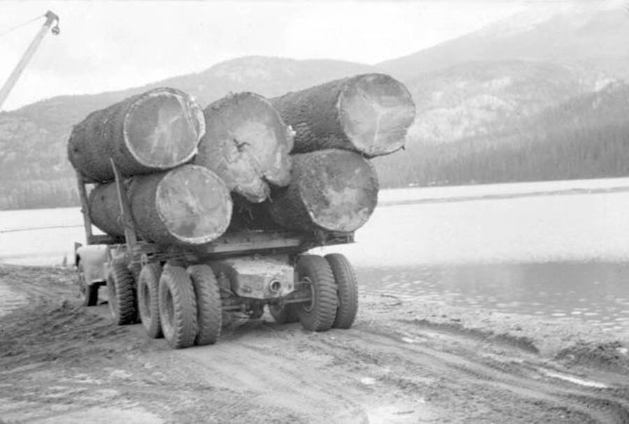 View of the back of a log truck loaded down with five logs. Donated by Speed Weidner through Priest Lake Museum.