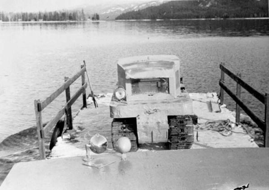 A caterpillar machine siting on a barge. Donated by Speed Weidner through Priest Lake Museum.