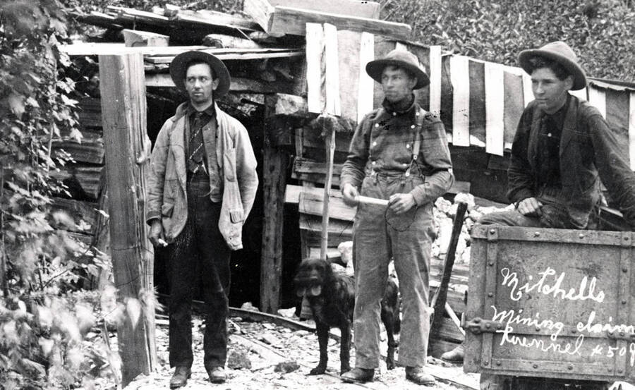Bill Brawley, Leonard Paul, and Bob Gumaer stand outside the Mitchells Mining Claim. Donated by Marjorie (Paul) Roberts through Priest Lake Museum.