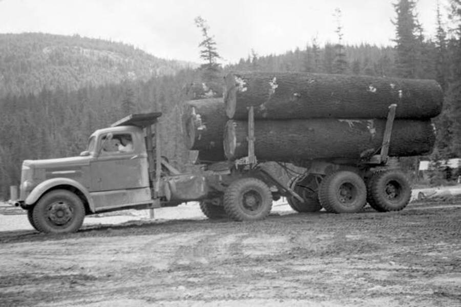 Side view of a loaded logging truck. Donated by Speed Weidner through Priest Lake Museum.