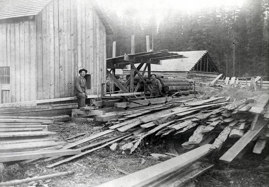 Albert Hagman and Ed Hampshire working at a sawmill.