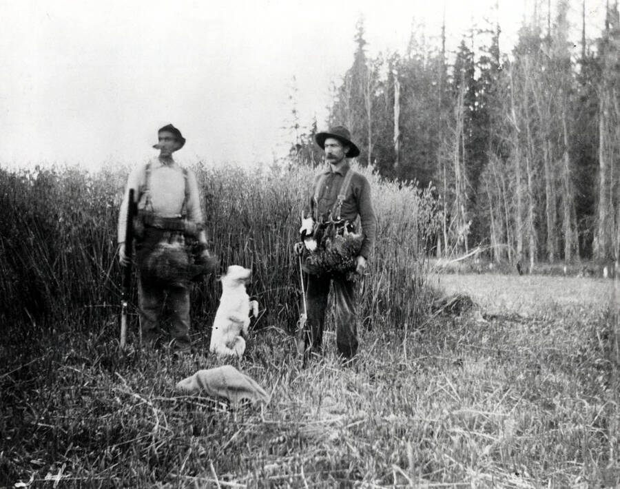 Ed Geugler and Frank Lilya pictured while bird hunting with a dog.