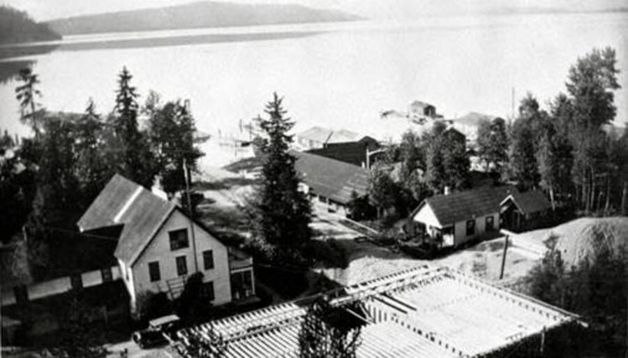 Taken from hill behind, shows new Leonard Paul store under construction. Also shows Priest Lake. Coolin, Idaho. Donated by Marjorie Paul Roberts via Priest Lake Museum.