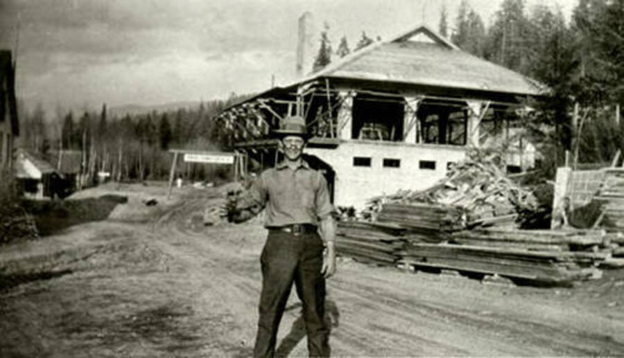 A man stands in front of the new Leonard Paul store while it is under construction. Donated by Marjorie Paul Roberts via Priest Lake Museum.
