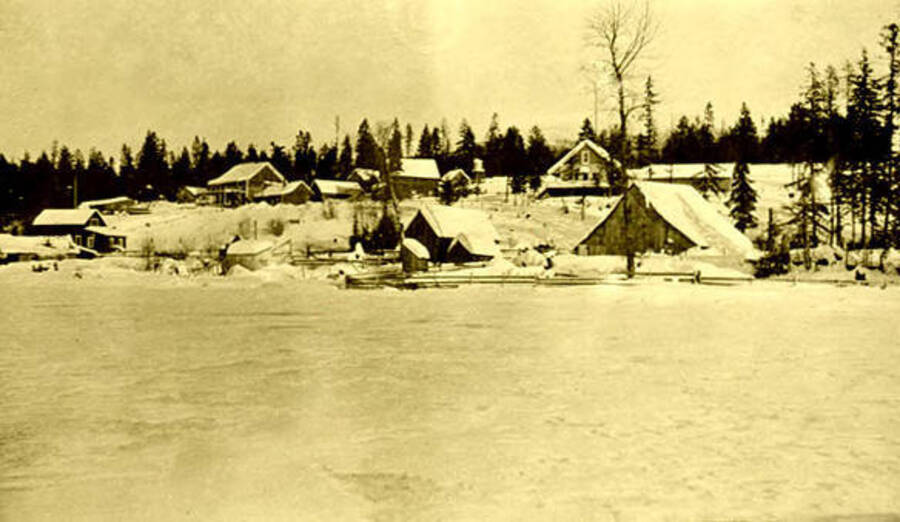 Coolin waterfront during the winter. A barn and the Northern Hotel can be seen in the background. Coolin, Idaho. Donated by Harriet (Klein) Allen via Priest Lake Museum.
