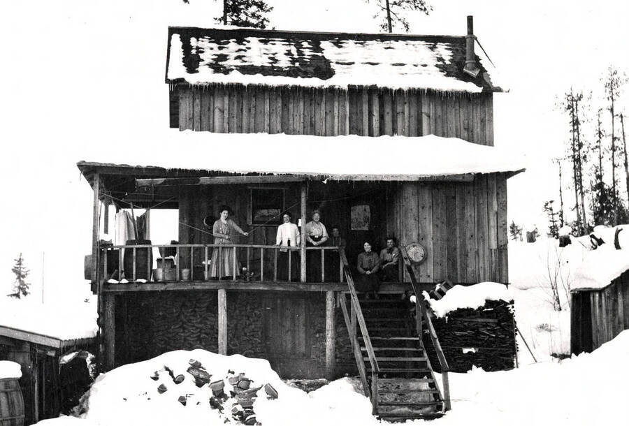 Six women on the porch of the Leonard Paul home in winter. Coolin, Idaho. Donated by Dorothy Bruno through Priest Lake Museum.