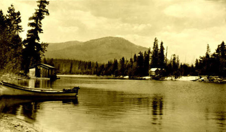 Duffill cabin on the Thorofare River. Cabin is on the left side of the water. Donated by Marjorie Paul Roberts via Priest Lake Museum.
