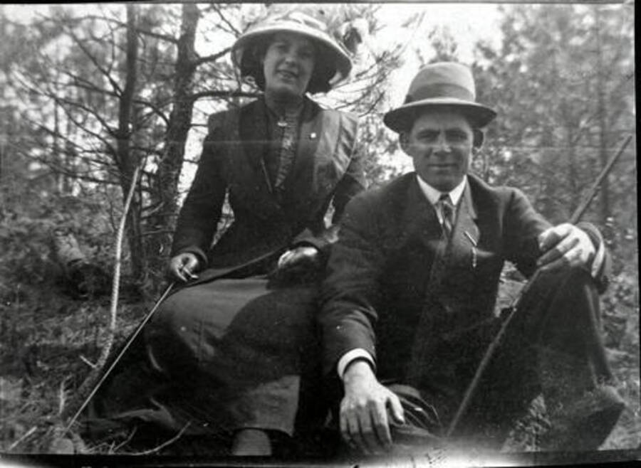 Astor and Wirt Calfee pose for a photograph in a wooded area. Donated by Margaret Randall through Priest Lake Museum.