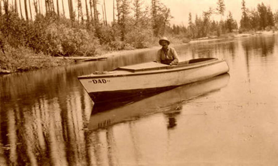"Dad" Moulton sitting in a boat floating on the Thorofare River. Donated by Marjorie Paul Roberts via Priest Lake Museum.