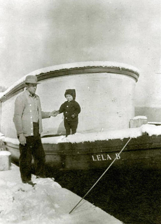 Lela B. and Fred Scheider with the Lela B. boat. Donated by William Warren through Priest Lake Museum.