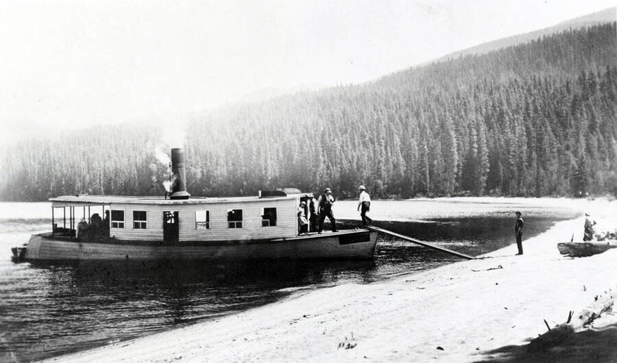 The steamboat W. W. Slee near the beach. People can be seen on the beach and on the boat. Donated by Harriet (Klein) Allen through Priest Lake Museum.