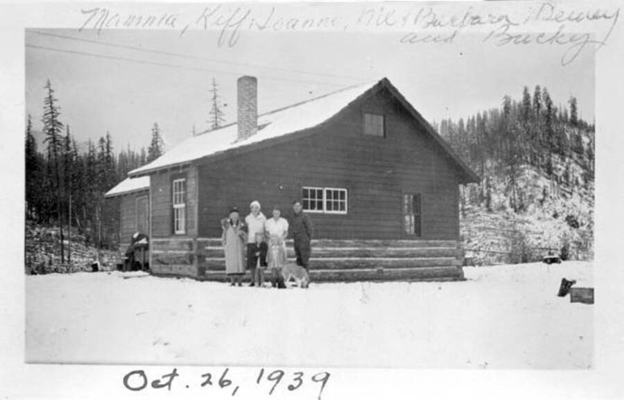 People posed out the Ranch home during the winter. Donated by Dewey Huot through Priest Lake Museum.