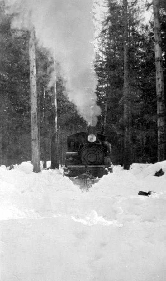 Bert Winslow plowing at Dalkenia Camp during the winter. L Engine #1. Idaho. Donated by Mike Winslow through Priest Lake Museum.