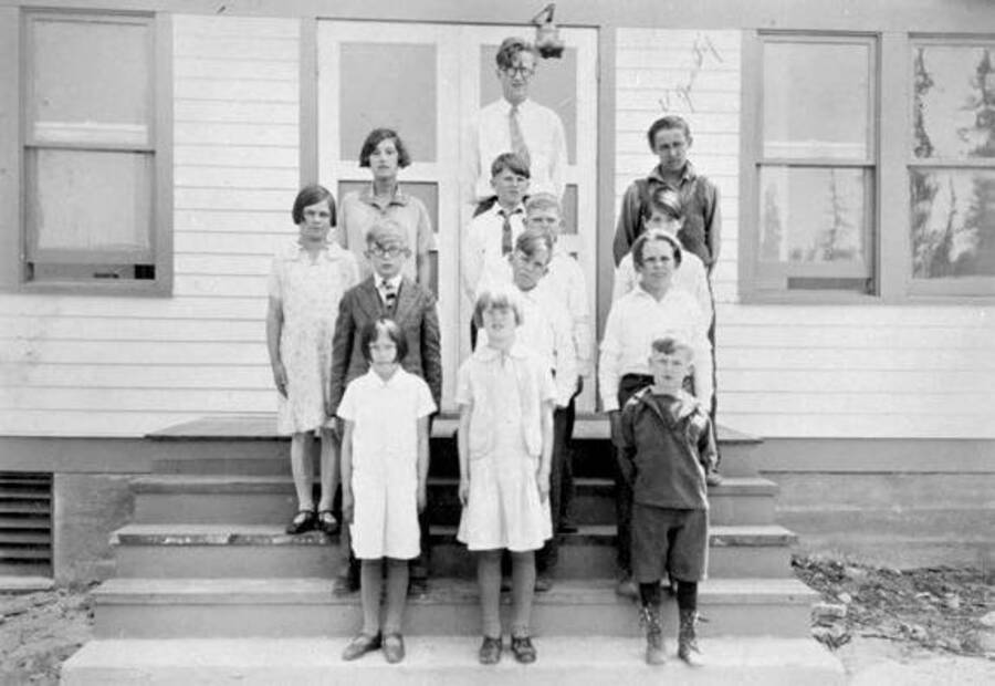 Twelve students and a teacher on the steps of Nordman School in Nordman, Idaho. Donated by Mike Winslow through Priest Lake Museum.