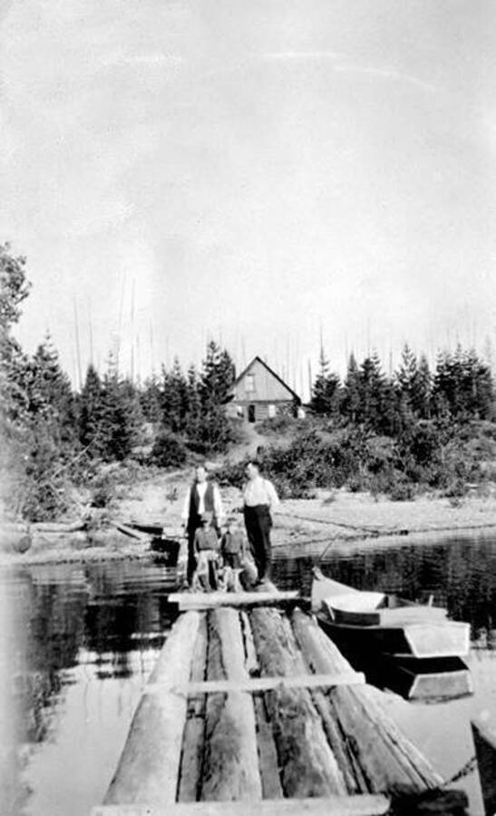 Frosty and Scotty (standing in front of adults) at the Winslow homestead on Reeder Creek. Donated by Mike Winslow through Priest Lake Museum.