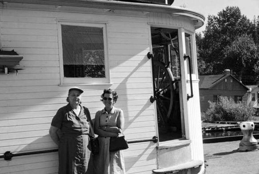Two women stand outside of the wheelhouse of the stemaboat Tyee. Donated by Paul Weber through Priest Lake Museum.