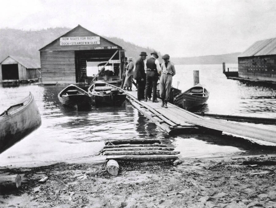 People standing on the dock at the Coolin Marina. in Coolin, Idaho. Donated by Harriet (Klein) Allen through Priest Lake Museum.