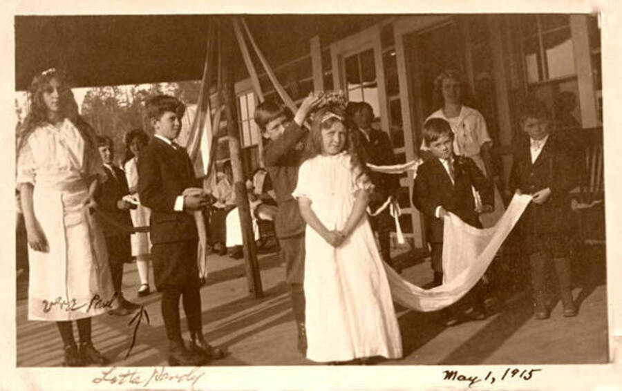 Maypole at Northern Hotel in Coolin, Idaho. Picture: Vera Paul (far-left, holding train on left), Jack Moore, Lotta Handy, Handy's granddaughter in back. Donated by Marjorie Paul Roberts via Priest Lake Museum.
