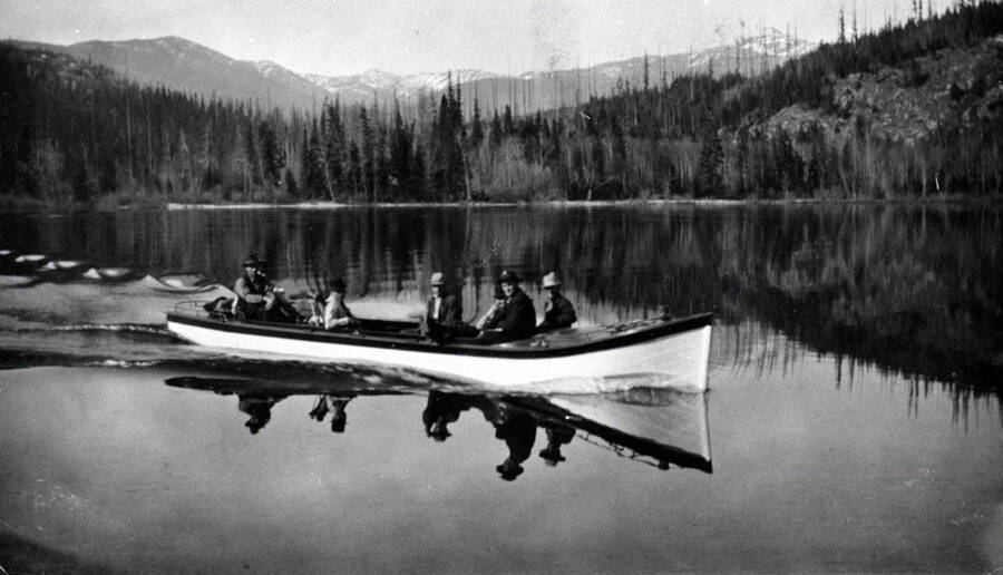 Hunting party in a boat near the Thorofare River. Donated by Marjorie (Paul) Roberts through Priest Lake Museum.