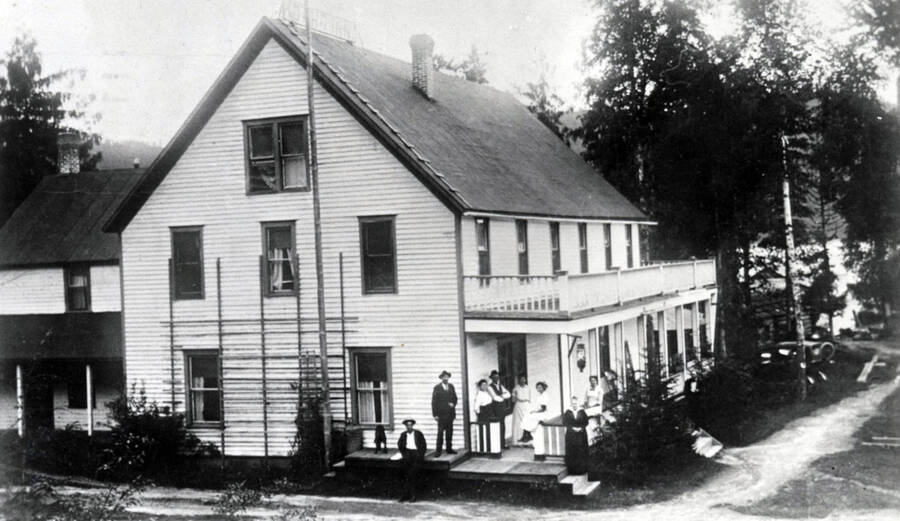 People standing on the porch of the Idaho Inn in Coolin, Idaho. Donated by Marjorie (Paul) Roberts through Priest Lake Museum.