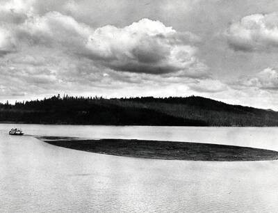 View of steamboat Tyee pulling a log boom on Priest Lake, Idaho. Donated by Russ Bishop through Priest Lake Museum.
