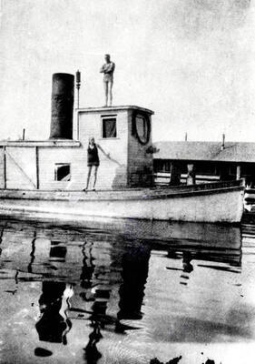 A man and woman in swim suits on the steamboat E. W. Harris.