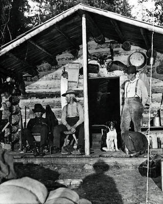 Three men in front of the Slee cabin. Donated by Harriet (Klein) Allen through Priest Lake Museum.