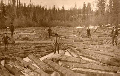 Men working on a log drive on river. Donated by Marjorie Paul Roberts via Priest Lake Museum.