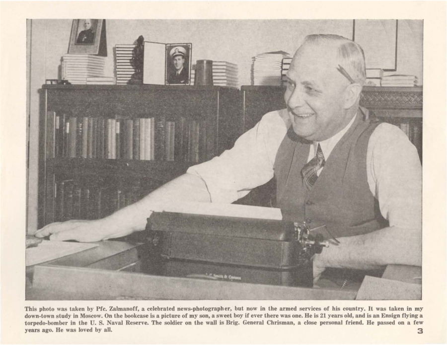 Photograph of Robinson sitting at a desk in his 'down-town study.' Text follows that regarding the taker of the photograph, and details of the scene, including notes on a photograph of Robinson's son.