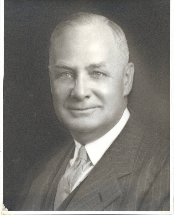 Portrait of middle-aged Frank B. Robinson dressed in a three piece pin-striped suit and tie.