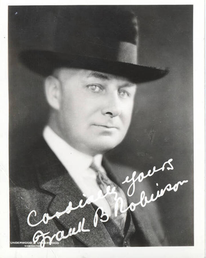 Portrait of middle-aged Frank B. Robinson wearing a three piece suit and homburg hat and signed with the  message, 'Cordially Yours, Frank B. Robinson.'