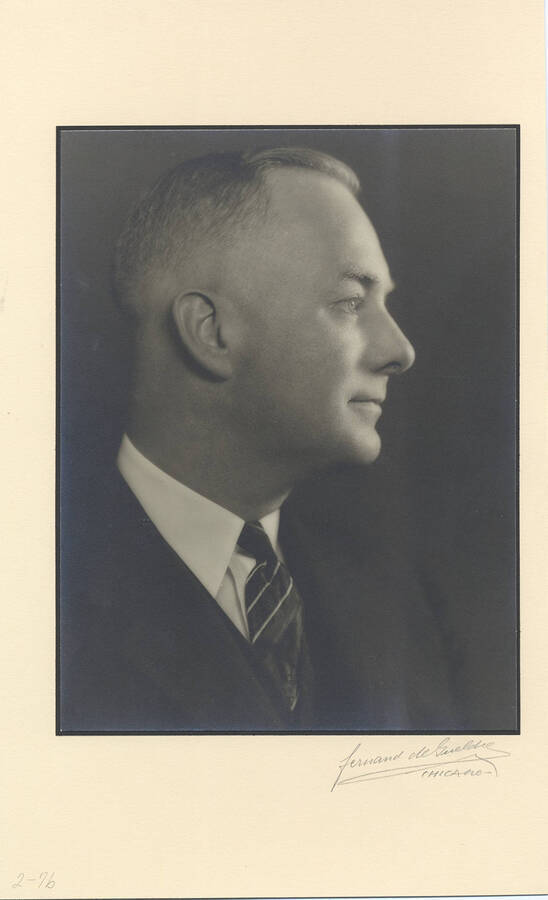 Portrait of young Frank B. Robinson wearing a three-piece suit and tie looking away from the camera.