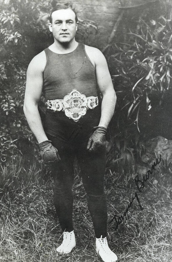 Signed portrait of world heavyweight boxing champion Tommy Burns at the age of 27, wearing his heavyweight belt with a personal note to Frank B. Robinson on back.