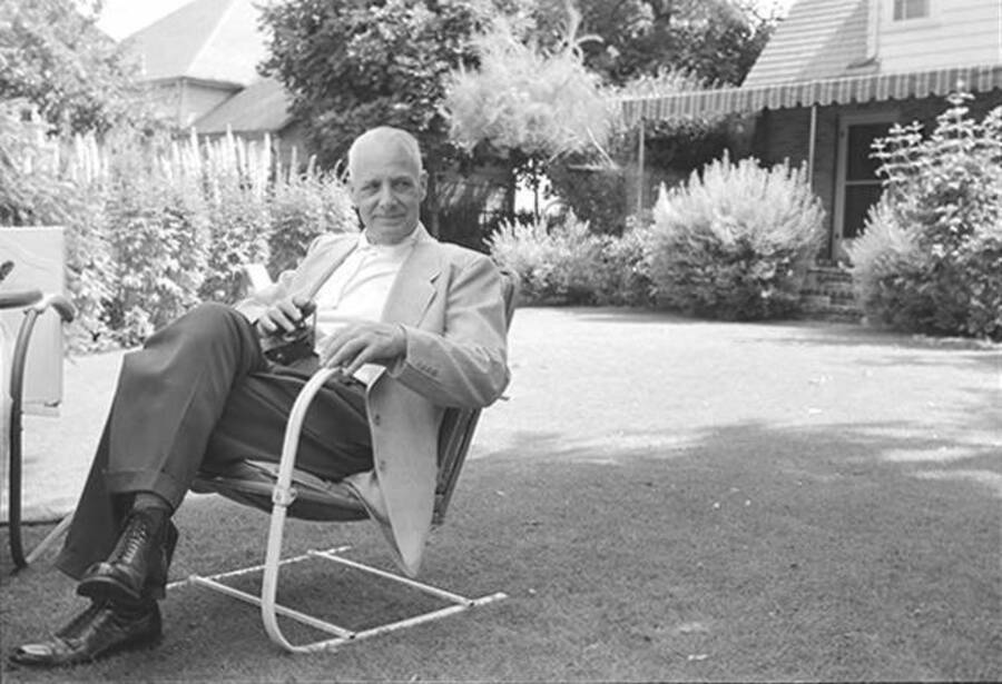 Photograph depicts an older Frank B. Robinson in formal clothes sitting outside in a chair on the lawn.
