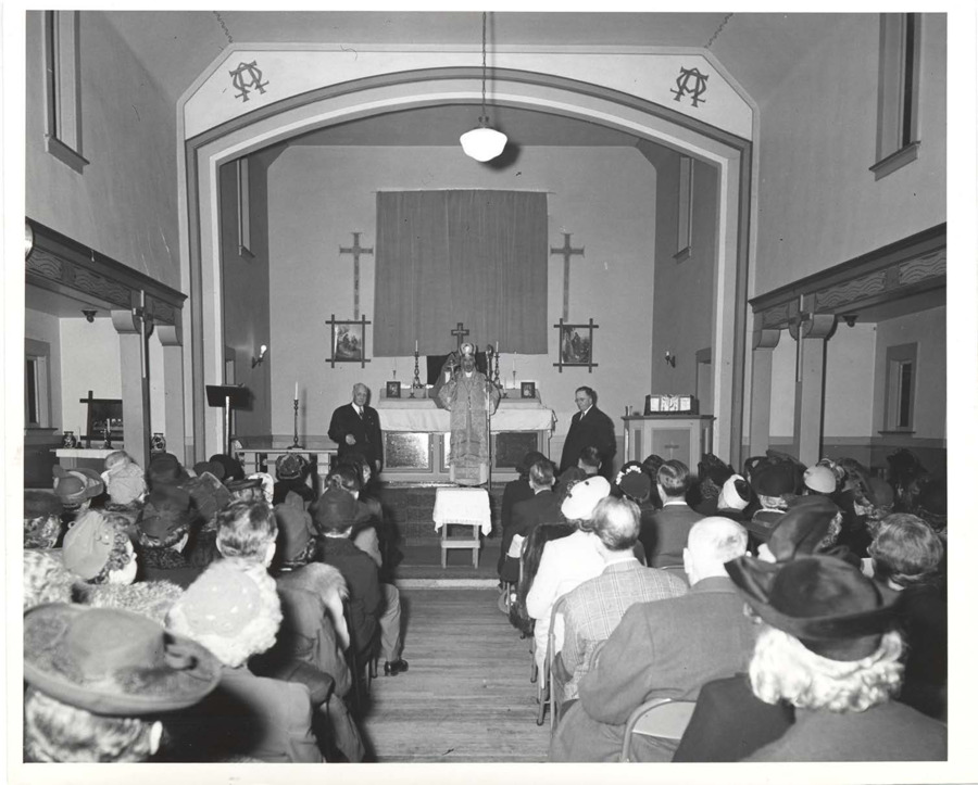 Page 1 photograph of the inside of a church during a ceremony; page 2-5 includes documents verifying Antonious Joseph Aneed's status as Archbishop; page 6 newspaper clipping raises allegations against the consecration of Antonious Joseph Aneed and therefore ordination and consecration of Frank B. Robinson as priest and bishop; page 6-8 documentation of Antonious Joseph Aneed in Syrian.