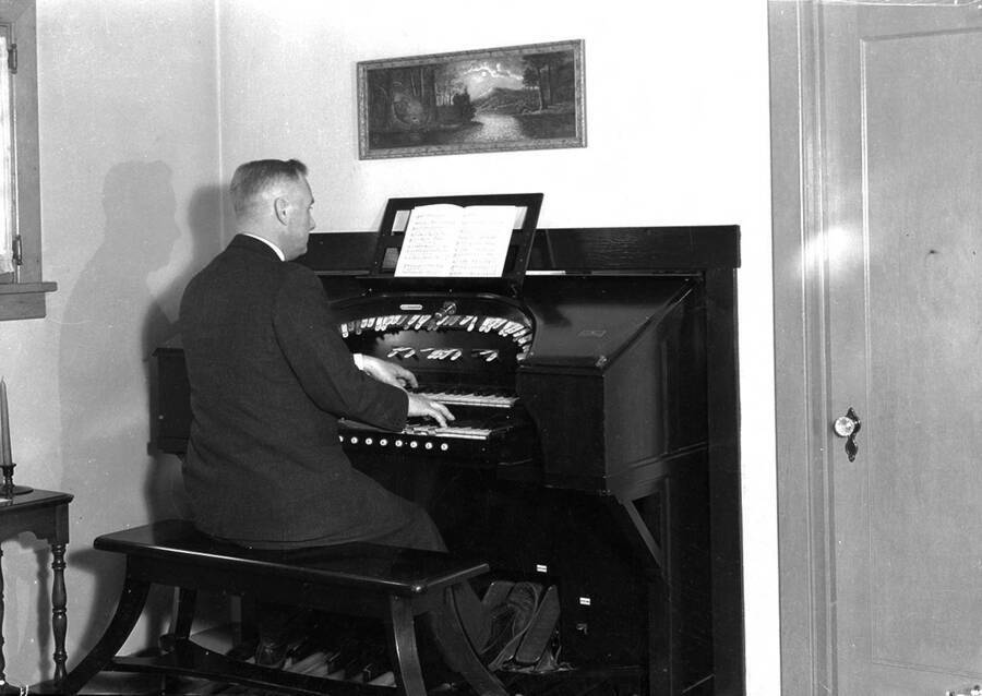 Photograph of Frank B. Robinson playing his pipe organ.