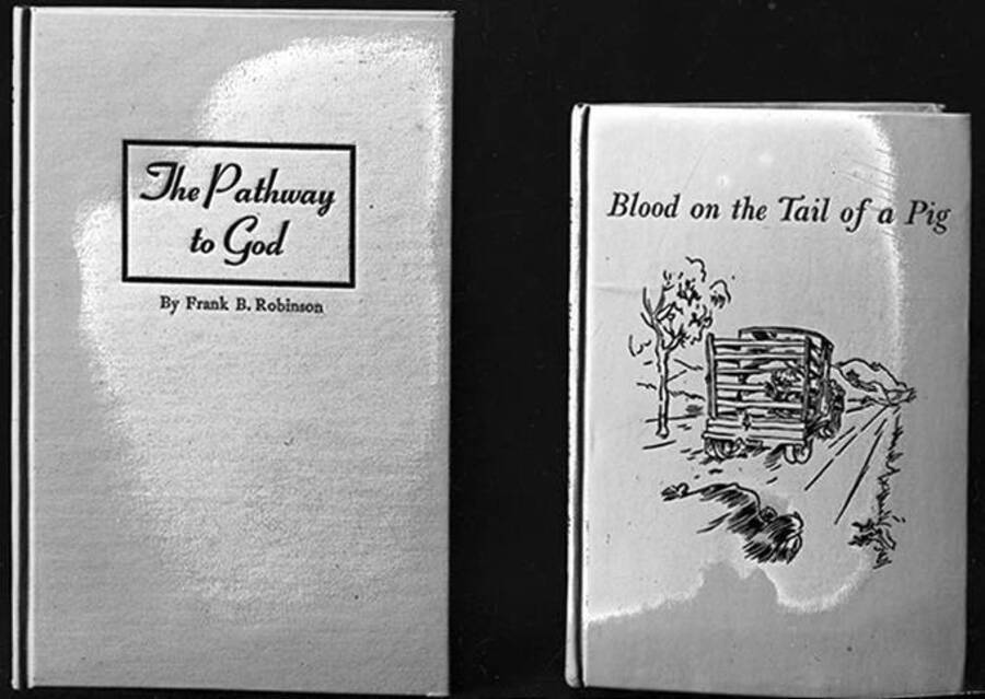 Negative includes photographs of Frank B. Robinson's books, The Pathway to God and Blood on the Tail of a Pig, the latter having a cover with a  drawing of a truck driving away on a dirt road.