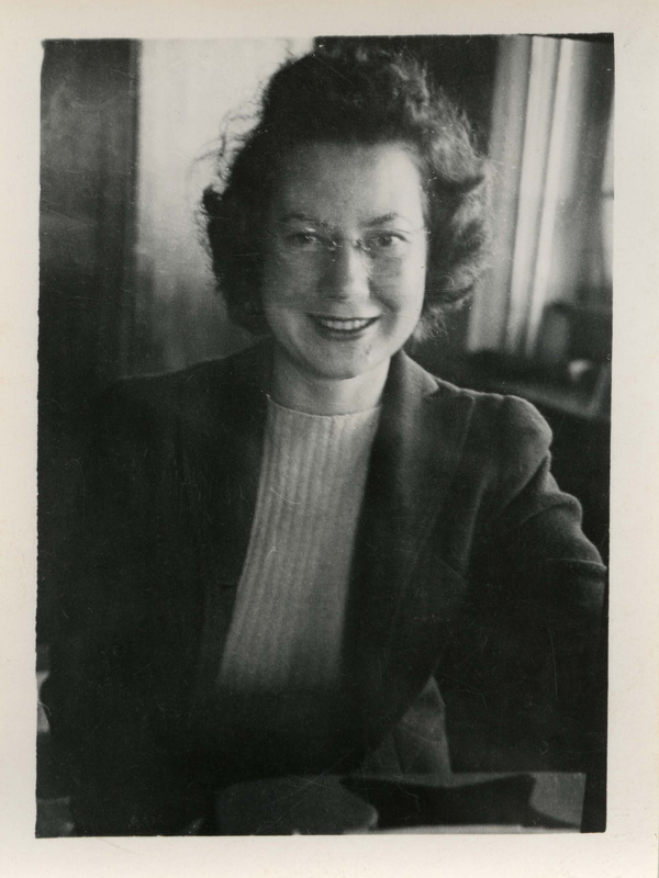 Jean Chandler, Forestry School Secretary, smiling at the camera, in an office setting.