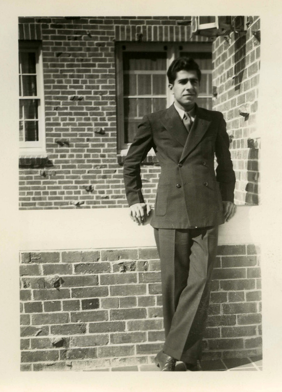 Phil Habib was the second semester of sophomore year roommate to Franklin Raney. He is standing outside next to a brick building.