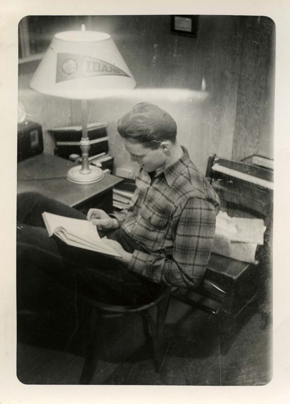 Franklin Raney reading a book in room 56 in the Idaho Club.